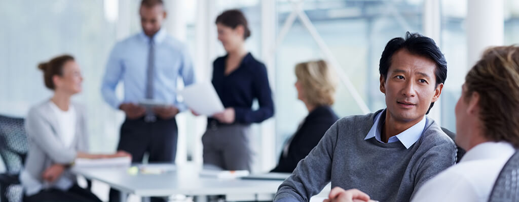 Investing Abroad: International Desk International Desk Manager talking to a customer about investing abroad
